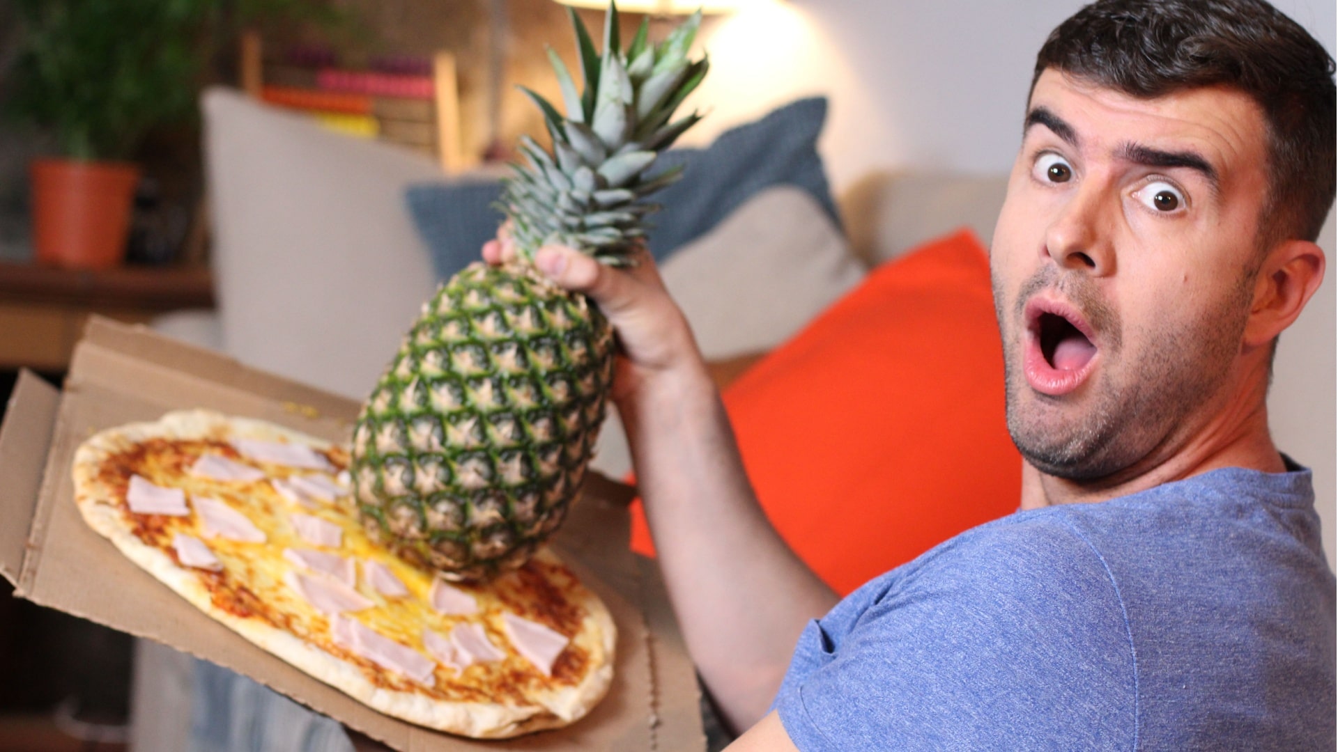 Funny man holding pineapple and pizza