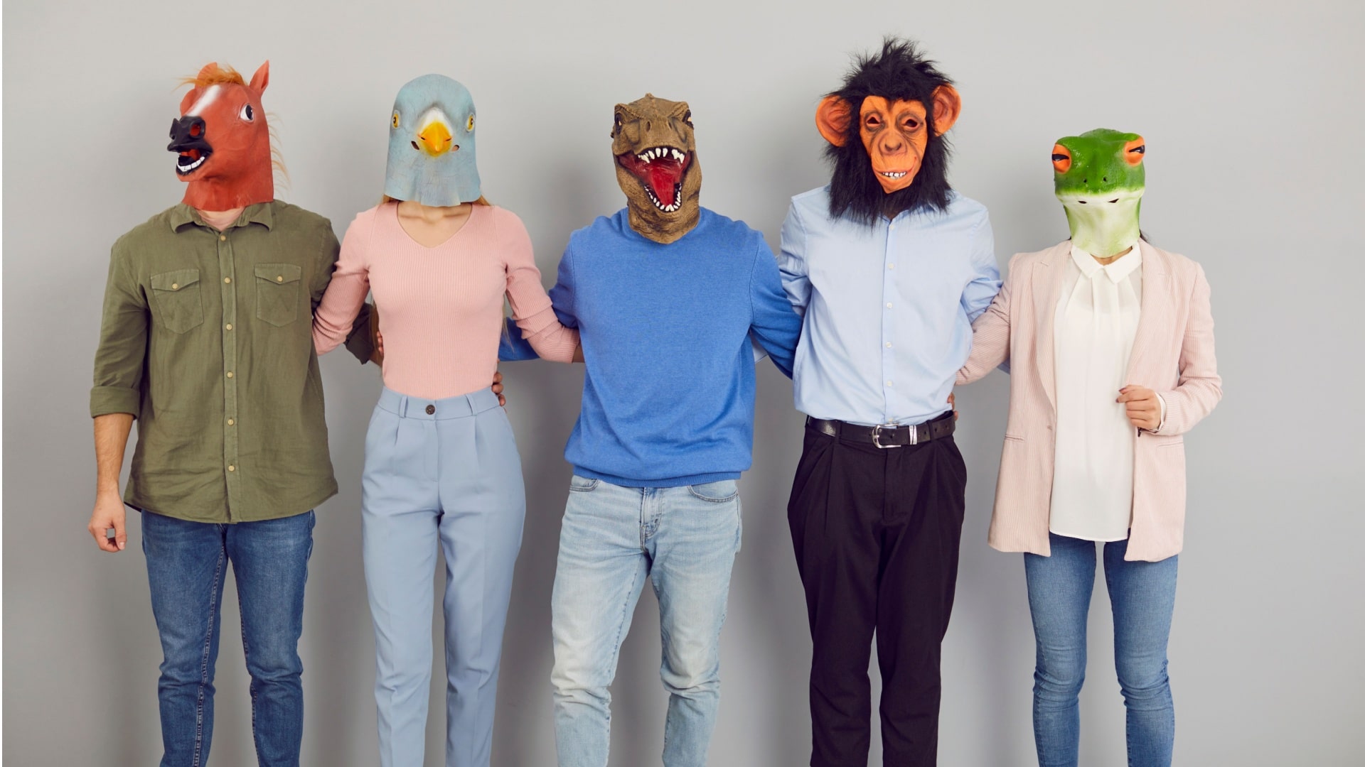 Team of happy young people wearing funny masks