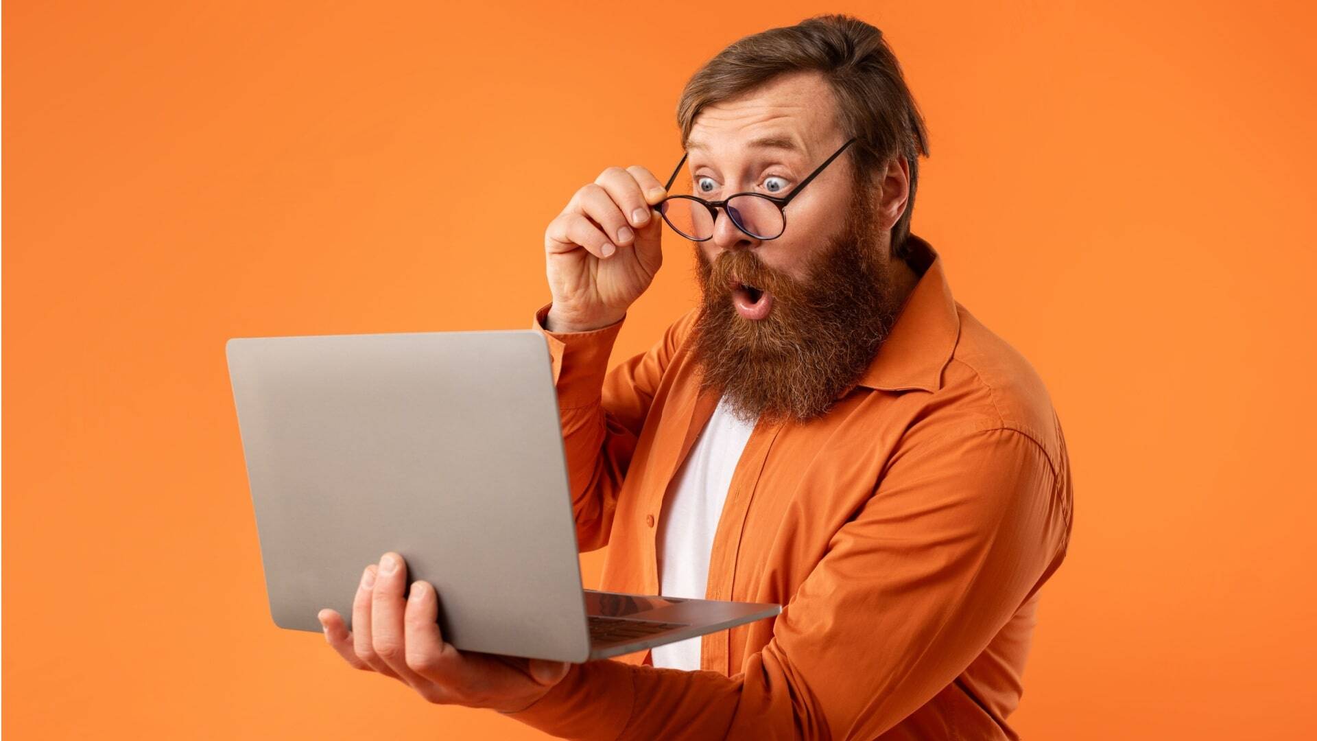 guy with red hair and beard looking at laptop computer