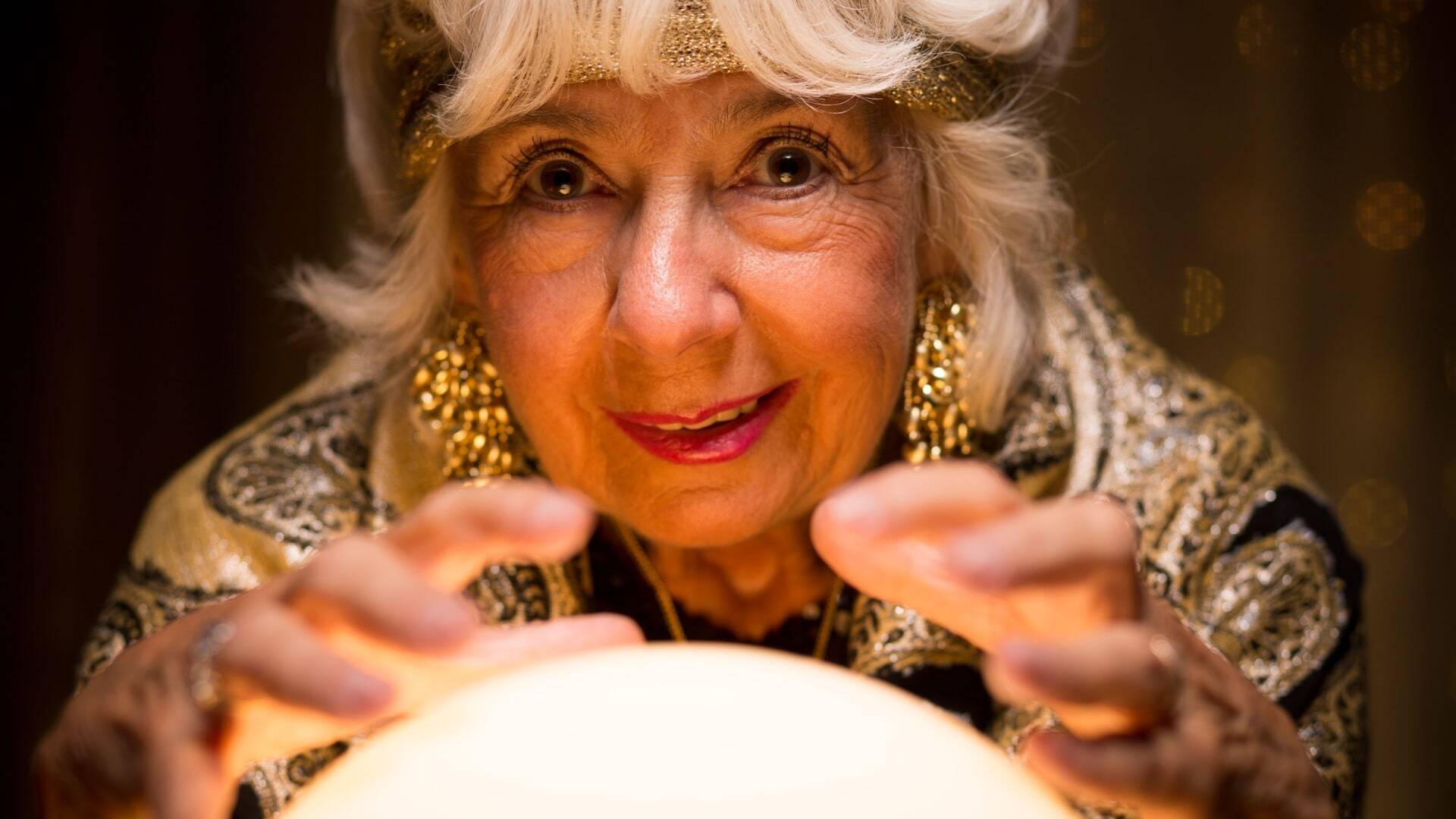 Old fortune teller is strange with her crystal ball