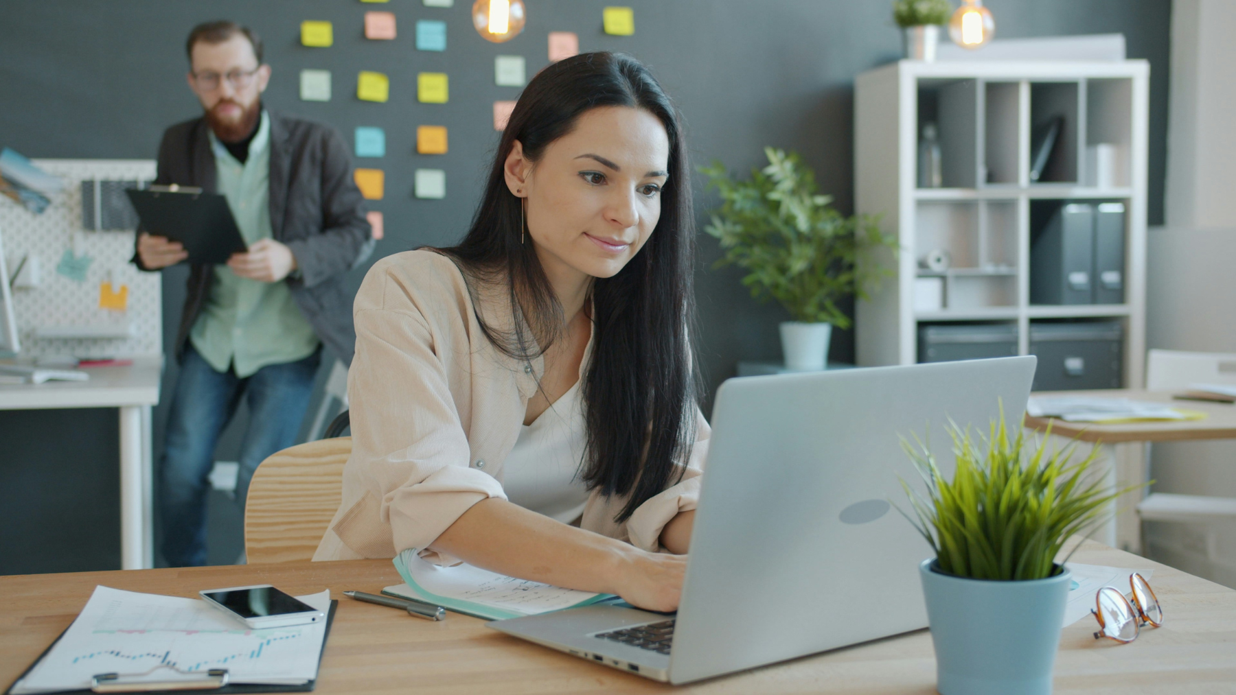 Woman at computer updating CRM